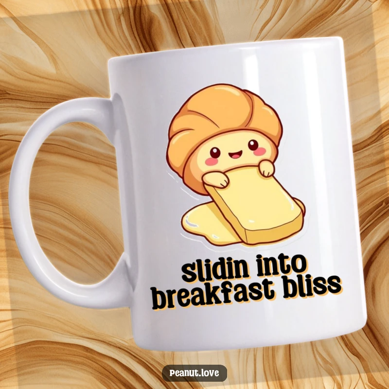 Funny mug showing a cute croissant character sliding playfully down a butter pat.