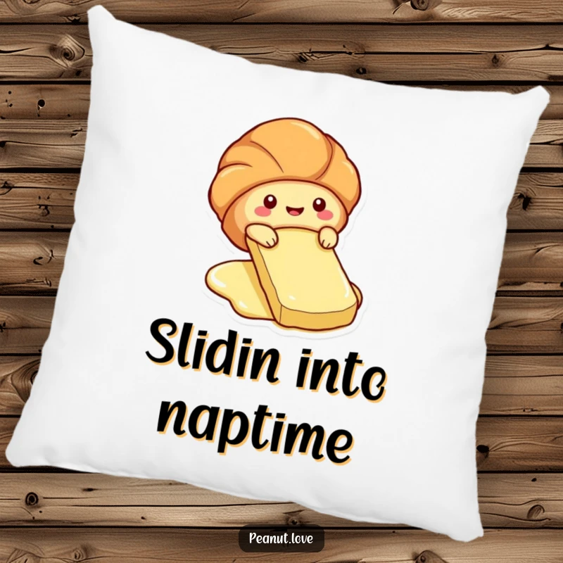 Funny pillow depicting a cute croissant character sliding down a butter pat.