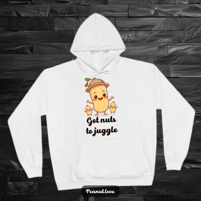 Funny hoodie featuring a cheerful peanut character in a hat, skillfully juggling multiple peanuts with a happy expression.