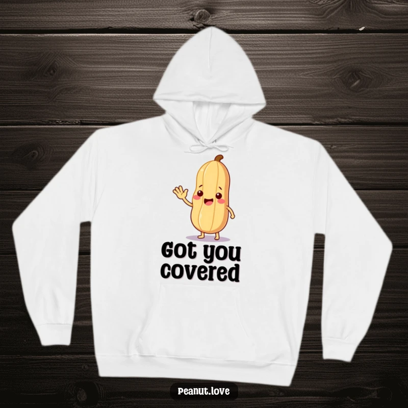 Funny Kind Peanut Hoodie: A friendly peanut waving and offering a leaf, providing cozy, funny, and welcoming warmth.