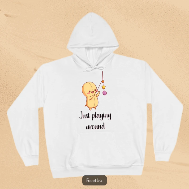 Funny peanut character batting at a dangling string with enthusiasm, featured on a cozy hoodie, playful and active design.