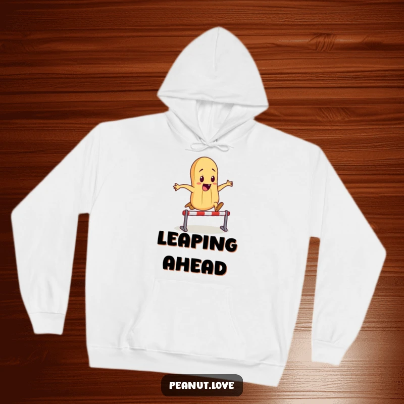 Funny hoodie showing a determined anthropomorphic peanut character leaping with all its might over a tiny hurdle, embodying fun.