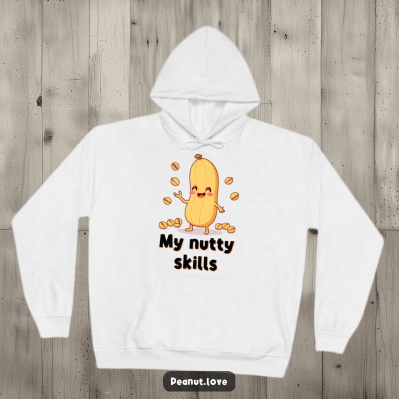 Funny Peanut Juggling Hoodie: A warm hoodie with an anthropomorphic peanut character comically juggling tiny nuts with its shell, perfect funny gift.