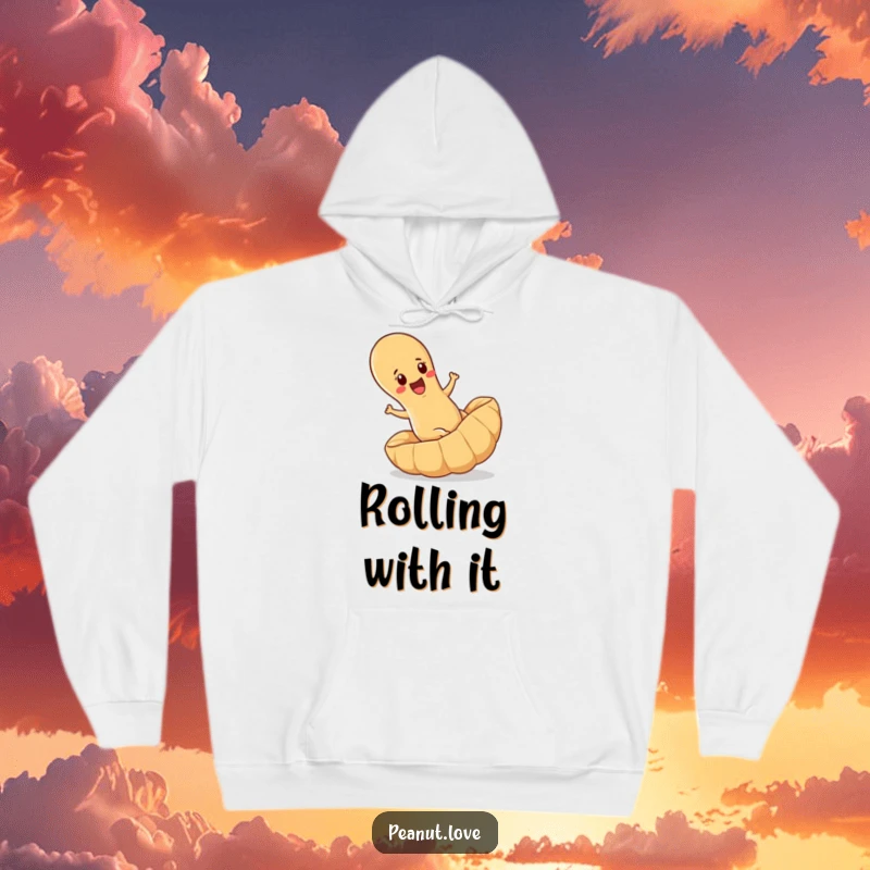 Funny hoodie depicting a determined peanut joyfully rolling downhill inside a massive peanut shell, offering comfort and humor.
