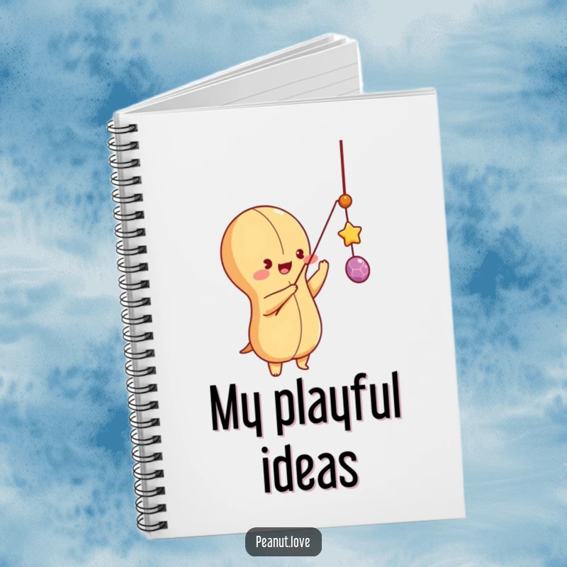 Funny peanut character batting at a dangling string, on a notebook cover, perfect for capturing spontaneous ideas.