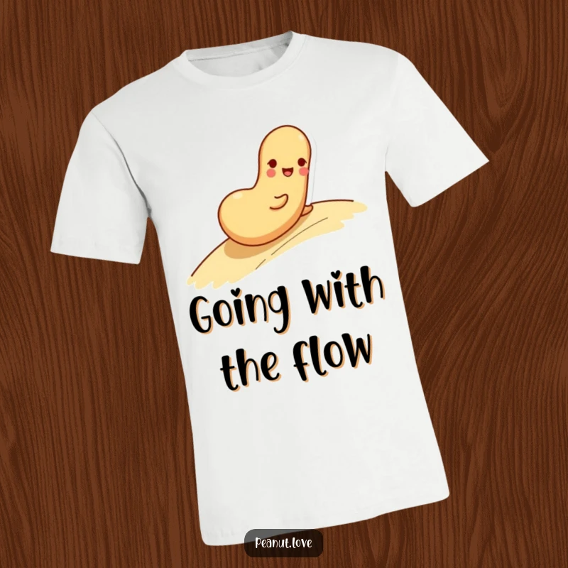 Funny t-shirt showing a playful peanut character rolling happily down a slope with a cheerful face.