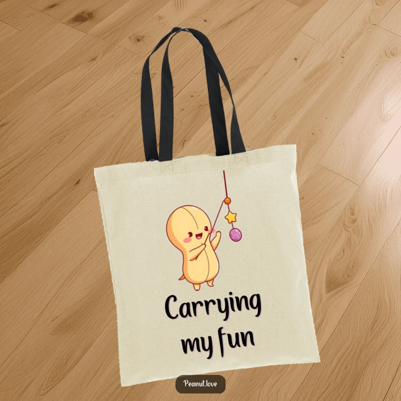 Funny peanut character batting at a dangling string, on a durable tote bag, symbolizing fun and active play.